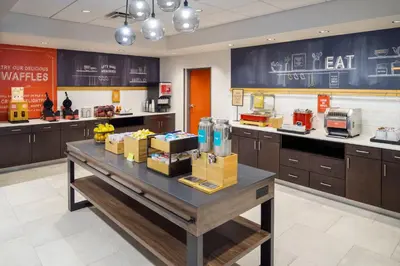 a kitchen with a table with boxes of food on it at Hampton Inn Kissimmee North in Kissimmee