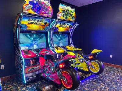a pinball machine with two motorcycles parked in it at Townhome w pool near Disney & Orlando Attractions in Kissimmee