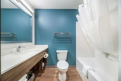 a bathroom with a toilet and a sink and a tub at Extended Stay America Select Suites - Orlando - Kissimmee in Orlando