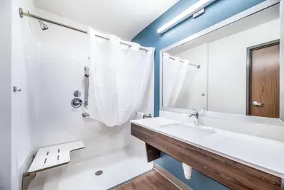 a bathroom with a sink and a mirror at Extended Stay America Select Suites - Orlando - Kissimmee in Orlando