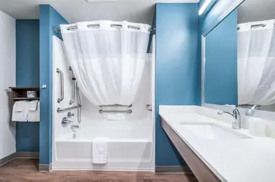 a bathroom with a tub and a sink and a shower at Extended Stay America Select Suites - Orlando - Kissimmee in Orlando