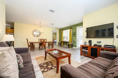 a living room with a couch and a table at Premium Lake View Condo, Vista Cay - 1005 in Orlando