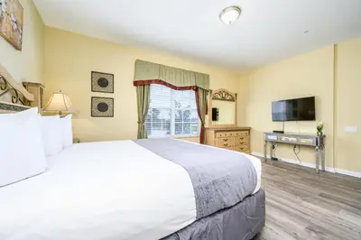 a bedroom with a large bed and a flat screen tv at Premium Lake View Condo, Vista Cay - 1005 in Orlando