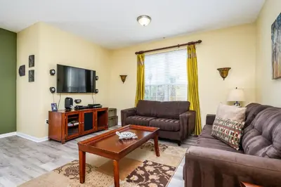 a living room with a couch and a tv at Premium Lake View Condo, Vista Cay - 1005 in Orlando