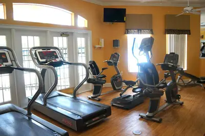 a gym with five exercise bikes in a room at Gated Emerald island resort townhome, Overlook Pool, 3 miles to Disney, rent by owner in Kissimmee
