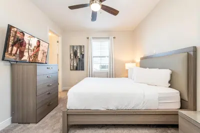 a bedroom with a bed and a ceiling fan at Elegant Home Near Disney With Private Pool, Foosball Table, Themed Rooms And Waterpark & Resort Access At Encore Resorts Reunion - 365Sf in Kissimmee