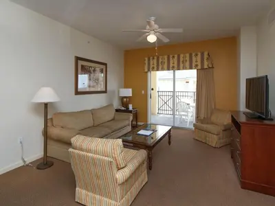a living room with a couch and a tv at Luxury Resort Condo, 2 or 3 BR, Premium suites in Orlando