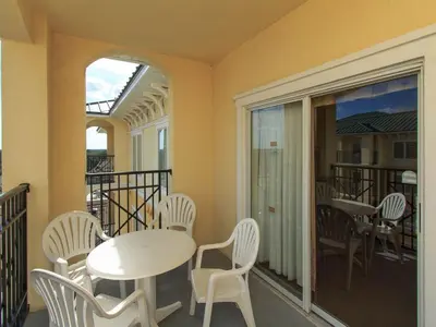 a room with a table and chairs on a balcony at Luxury Resort Condo, 2 or 3 BR, Premium suites in Orlando
