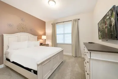 a bedroom with a white bed and a window at Spacious Home With Game Room, Private Pool And Waterpark & Resort Access Near Disney At Encore Resorts Reunion - 241Sf in Kissimmee