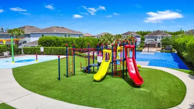 a playground with a slide in a park at Grand Home Near Disney With Private Pool, Air Hockey Table And Waterpark & Resort Access At Encore Resorts Reunion - 401Sf in Kissimmee