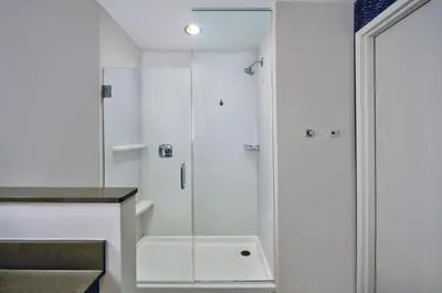 a shower with a glass door in a bathroom at Fairfield by Marriott Inn & Suites Orlando at FLAMINGO CROSSINGS® Town Center in Orlando
