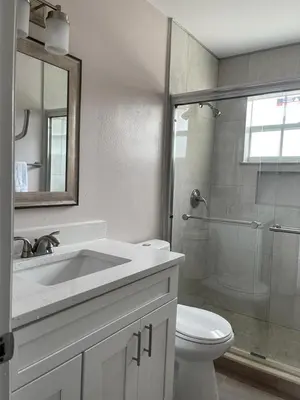 a bathroom with a toilet and a sink and a shower at Grand Family Premium 3BR Condo near Disney Parks in Kissimmee