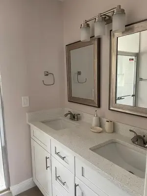 a bathroom with two sinks and a mirror at Grand Family Premium 3BR Condo near Disney Parks in Kissimmee