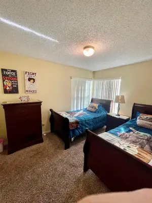 a bedroom with two beds and a window at Grand Family Premium 3BR Condo near Disney Parks in Kissimmee
