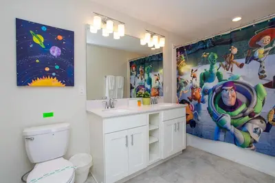 a bathroom with a sink and a toilet and a painting at Luxurious 2 Bd Close to Disney @ Storey Lake 204P in Kissimmee