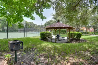 a gazebo on a tennis court with a trash can at Near Disney and Epic Universe Home with Resort Perks in Kissimmee