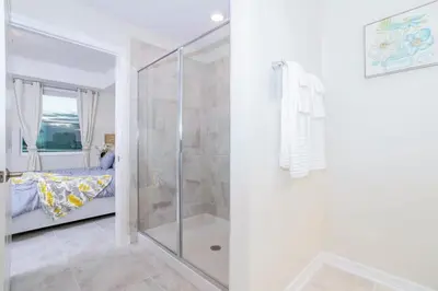 a bathroom with a shower and a bed in a room at Stunning 3Bd Apto Close to Disney 201P in Kissimmee