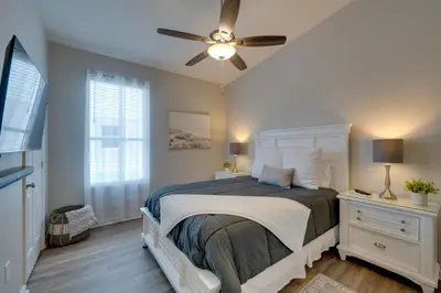 a bedroom with a bed and a ceiling fan at Pool, Themed Rooms and Arcade Disney Escape in Kissimmee