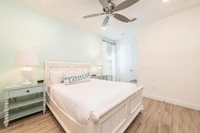 a white bedroom with a bed and a ceiling fan at Sunset On Shaker Cottage With Private Pool Near Disney With Margaritaville Resort & Island H20 Access - 7960Sh in Orlando
