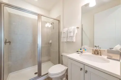 a bathroom with a shower and a toilet and a sink at Sunset On Shaker Cottage With Private Pool Near Disney With Margaritaville Resort & Island H20 Access - 7960Sh in Orlando