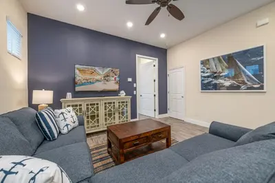 a living room with a couch and a table at Cocktails & Dreams Cottage With Private Pool Near Disney With Margaritaville Resort & Island H2O Access - 8005St in Orlando