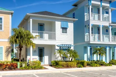 aominium building with palm trees in front of it at Comfy Cottage Near Disney With Margaritaville Resort & Island H2O Access - 8087Kd in Orlando