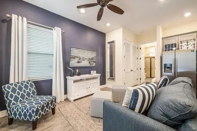 a living room with a couch and a chair at Comfy Cottage Near Disney With Margaritaville Resort & Island H2O Access - 8087Kd in Orlando