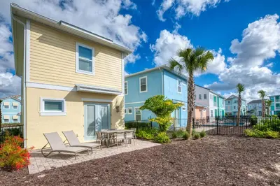 a house with a patio with chairs and a table at Brilliant Cottage Near Disney With Margaritaville Resort & Island H2O Access - 8090Kd in Orlando