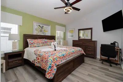 a bedroom with a bed and a ceiling fan at Making Dreams 4BR Family Villa with Pool and Game Room Near Disney Parks in Kissimmee