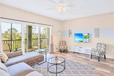 a living room with a couch and a tv at Bright & Airy 3BR Suite Near Disney - Pool in Orlando