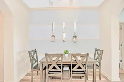 a dining room with a wooden table and chairs at Bright & Airy 3BR Suite Near Disney - Pool in Orlando