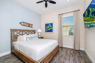 a bedroom with a bed and a window at Pineapple Dream Cottage With Private Hot Tub Near Disney With Margaritaville Resort & Island H2O Access - 8000Sb in Orlando
