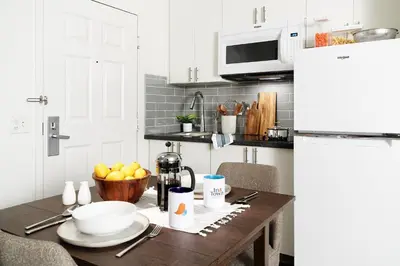 a kitchen table with a bowl of fruit on it at InTown Suites Extended Stay Orlando FL – Presidents Dr in Orlando