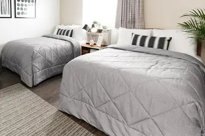 a bedroom with two twin beds and a table at InTown Suites Extended Stay Orlando FL – Presidents Dr in Orlando