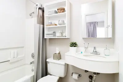 a white bathroom with a sink and a toilet at InTown Suites Extended Stay Orlando FL – Presidents Dr in Orlando