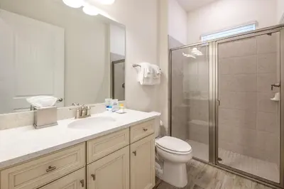 a bathroom with a toilet and a sink and a shower at Inviting Cottage Near Disney With Margaritaville Resort & Island H2O Access - 8009St in Orlando