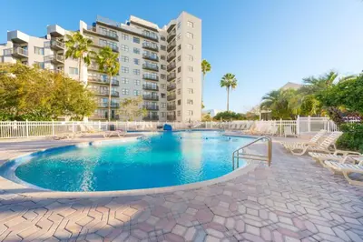 a swimming pool in front of a apartment building at Modern Studio on I-Drive: parking + pool included in Orlando