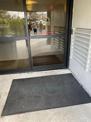 a glass door with a mat in front of it at Modern Studio on I-Drive: parking + pool included in Orlando