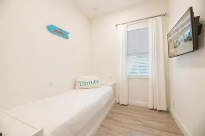 a white room with a bed and a window at Vivid Cottage Near Disney With Margaritaville Resort & Island H2O Access - 8020Ff in Orlando