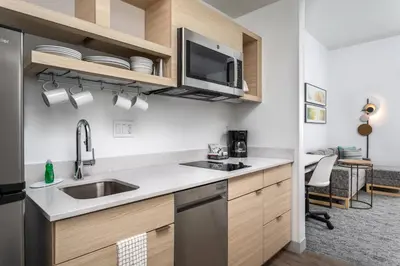 a kitchen with a sink and a microwave at TownePlace Suites By Marriott Orlando Southwest Near Universal in Orlando