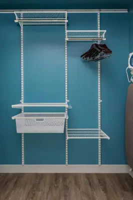 a blue wall with three steel shelving shelves at TownePlace Suites By Marriott Orlando Southwest Near Universal in Orlando
