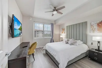 a bedroom with a bed and a ceiling fan at Luxury 3BR resort Condo walking distance to Epic Universe, Convention center and Icon Park in Orlando