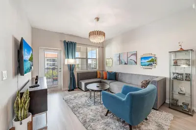 a living room with a couch and a table at Luxury 3BR resort Condo walking distance to Epic Universe, Convention center and Icon Park in Orlando