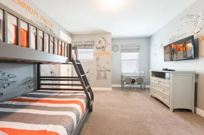 a bedroom with a bunk bed and a desk at Encore Resort 5 Bedroom Home with Pool 2100 in Orlando