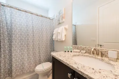 a bathroom with a sink and a toilet at Encore Resort 5 Bedroom Home with Pool 2100 in Orlando