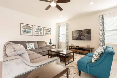 a living room with a couch and chairs at Encore Resort 5 Bedroom Home with Pool 2100 in Orlando