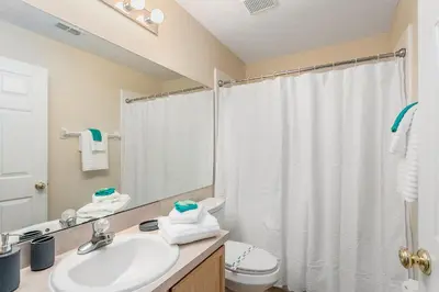 a bathroom with a sink and a toilet and a shower at South Facing Pool Deck - Private Outlook - Game Room - Family Friendly - Nr Disney in Orlando