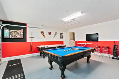 a room with two pool tables and a flat screen tv at South Facing Pool Deck - Private Outlook - Game Room - Family Friendly - Nr Disney in Orlando