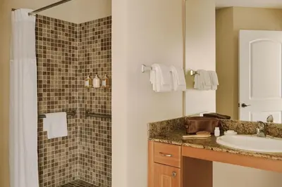 a bathroom with a sink and a shower at The Point by Edge in Orlando