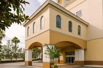a large yellow building with an archway at The Point by Edge in Orlando